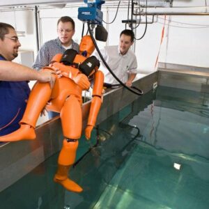 A human replica test dummy is lowered into the test pool ...